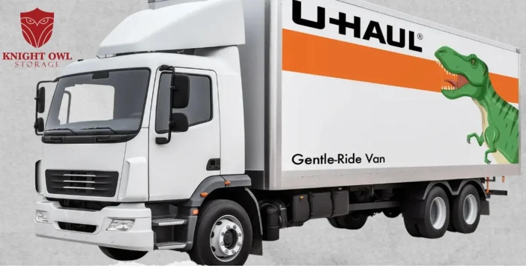 A white U-Haul moving truck with a green dinosaur graphic on the side next to the Knight Owl Storage logo.